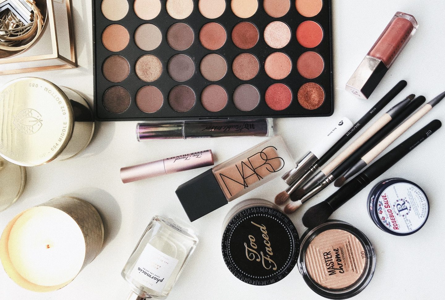 assorted makeup and skincare products on a white background