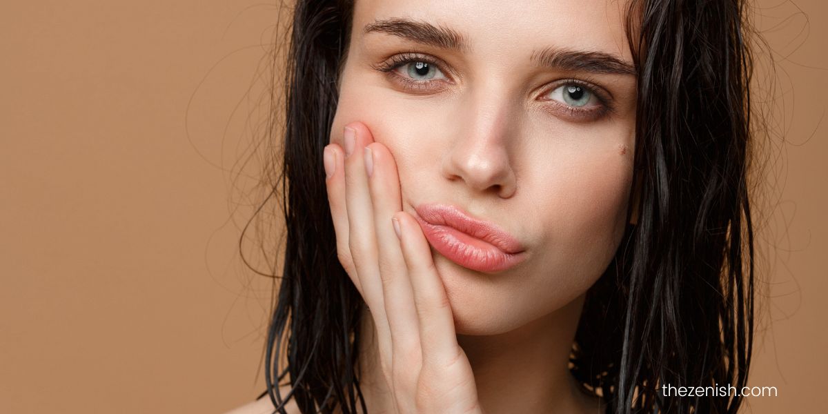 woman with hand on her jaw looking pensive